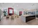 Open concept living room with kitchen featuring modern appliances, a fireplace, and lots of natural light at 5809 Cruiser Way, Tampa, FL 33615
