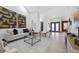 Spacious living room with modern art, light wood floors, and glass coffee table at 5809 Cruiser Way, Tampa, FL 33615