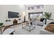 Bright living room featuring modern decor, stylish furnishings, and large windows with backyard view at 5809 Cruiser Way, Tampa, FL 33615