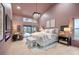 Luxurious bedroom with vaulted ceilings, access to the outdoor patio, and modern lighting at 5809 Cruiser Way, Tampa, FL 33615