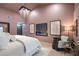 Inviting bedroom features a TV, linear fireplace, modern decor, and light-colored floors at 5809 Cruiser Way, Tampa, FL 33615