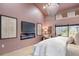 Modern bedroom with custom lighting, a linear fireplace, and light hardwood floors at 5809 Cruiser Way, Tampa, FL 33615