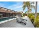 Pool deck with lounge chairs, palm trees and views of the screened-in pool at 5809 Cruiser Way, Tampa, FL 33615