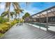 Pool deck with palm trees and view of screened-in pool at 5809 Cruiser Way, Tampa, FL 33615