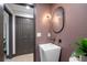 Chic powder room with vessel sink, modern lighting, and a mauve color scheme for a sophisticated touch at 5809 Cruiser Way, Tampa, FL 33615