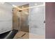 Contemporary shower boasts elegant tile work, glass enclosure, and modern fixtures at 5809 Cruiser Way, Tampa, FL 33615