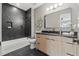 Modern bathroom featuring a vanity with wooden cabinets, black fixtures, and shower with black tiling at 807 W Park Ave, Tampa, FL 33602