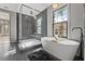 Modern bathroom featuring a soaking tub, walk-in shower, and dark tile flooring for a spa-like retreat at 807 W Park Ave, Tampa, FL 33602