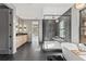 Bathroom featuring walk-in shower, stand alone tub, black tile floor, and modern double vanity at 807 W Park Ave, Tampa, FL 33602