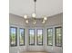 Sun-filled bay window with views from three large black framed windows and a decorative light fixture at 807 W Park Ave, Tampa, FL 33602