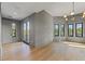 Spacious bedroom with hardwood floors, gray walls, lots of natural light, and a modern light fixture at 807 W Park Ave, Tampa, FL 33602