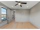 Spacious bedroom with hardwood floors, neutral walls, a window, and ceiling fan at 807 W Park Ave, Tampa, FL 33602