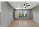 Bright bedroom with beautiful hardwood floors, modern ceiling fan, and ample natural light from dual windows at 807 W Park Ave, Tampa, FL 33602