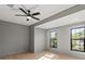 Bright bedroom featuring hardwood floors, a contemporary ceiling fan, and bright windows at 807 W Park Ave, Tampa, FL 33602