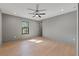 Spacious bedroom with hardwood floors, neutral walls, a window, and ceiling fan at 807 W Park Ave, Tampa, FL 33602