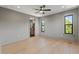 Spacious bedroom with hardwood floors, neutral walls, a window, and doorway to an attached bathroom at 807 W Park Ave, Tampa, FL 33602