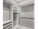 Spacious walk-in closet with custom white shelving and rods for organized storage, creating an efficient space at 807 W Park Ave, Tampa, FL 33602