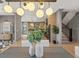 Spacious dining room with modern lighting fixtures and views into the kitchen and stairway at 807 W Park Ave, Tampa, FL 33602