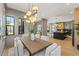 A dining room with many windows, an elegant light fixture, and views into an open kitchen at 807 W Park Ave, Tampa, FL 33602