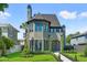 Charming two-story home showcasing stone accents, a well-manicured lawn, and lush landscaping at 807 W Park Ave, Tampa, FL 33602