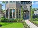 Elegant home featuring a stone archway, meticulous landscaping, and a welcoming front entrance at 807 W Park Ave, Tampa, FL 33602