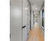Long hallway with hardwood floors and neutral walls, showcasing the home's spacious layout at 807 W Park Ave, Tampa, FL 33602