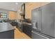 Spacious kitchen with stainless-steel appliances, dark countertops, and light wood cabinets for a modern design at 807 W Park Ave, Tampa, FL 33602