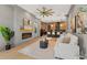 Open-concept living room with fireplace flows into a modern kitchen with bar seating at 807 W Park Ave, Tampa, FL 33602