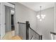 Staircase with modern railing and stylish lighting fixture, offering a glimpse into the modern bathroom at 807 W Park Ave, Tampa, FL 33602