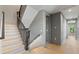 Staircase with wood stairs and black railing, illuminated with stylish lighting and neutral walls at 807 W Park Ave, Tampa, FL 33602