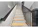 Elegant staircase with black railing and light wood treads at 807 W Park Ave, Tampa, FL 33602