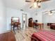 Comfortable bedroom with wood-look floors, ceiling fan, and mirrored closet at 8330 Vendome N Blvd, Pinellas Park, FL 33781