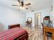 Spacious bedroom featuring a ceiling fan, wood-look floors, and light walls at 8330 Vendome N Blvd, Pinellas Park, FL 33781