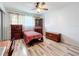 Comfortable bedroom featuring wood-look flooring, natural light, and a mix of furniture with classic charm at 8330 Vendome N Blvd, Pinellas Park, FL 33781
