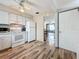 Bright kitchen showing appliances and an open doorway to the living room, highlighting functionality and flow at 8330 Vendome N Blvd, Pinellas Park, FL 33781