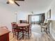 A view of the living room and dining area, showcasing the wood floors, furnishings, and ceiling fans at 8330 Vendome N Blvd, Pinellas Park, FL 33781