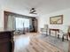 Bright living room featuring wood flooring, a ceiling fan, and furniture, creating a comfortable and inviting space at 8330 Vendome N Blvd, Pinellas Park, FL 33781