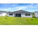 Well-maintained backyard with lush green grass and a modern home exterior at 8347 Golden Beach Ct, Parrish, FL 34219