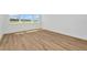 Bedroom featuring a bright window and wood-look flooring at 8347 Golden Beach Ct, Parrish, FL 34219
