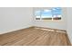 Bright bedroom with large window, and wood-look flooring at 8347 Golden Beach Ct, Parrish, FL 34219