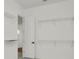 Spacious walk-in closet with metal shelving and a door to an adjoining room at 8347 Golden Beach Ct, Parrish, FL 34219