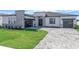 Single Gathering home exterior with a well manicured lawn and a modern garage door and minimalist landscaping at 8347 Golden Beach Ct, Parrish, FL 34219