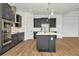 Modern kitchen features stainless steel appliances, dark cabinets, and a center island with a white countertop at 8347 Golden Beach Ct, Parrish, FL 34219