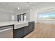 Kitchen island with white farmhouse sink and stylish cabinets featuring stainless steel dishwasher at 8347 Golden Beach Ct, Parrish, FL 34219