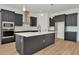 A large kitchen featuring a center island, stainless steel appliances, and dark modern cabinetry at 8347 Golden Beach Ct, Parrish, FL 34219
