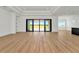 Spacious living area featuring sliding glass doors with view of backyard and pond at 8347 Golden Beach Ct, Parrish, FL 34219