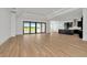 Open living space with sliding glass doors opening to the outside; kitchen visible in background at 8347 Golden Beach Ct, Parrish, FL 34219