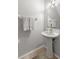 Powder room featuring tile floors, pedestal sink, and neutral walls at 8615 Hunters Key Cir, Tampa, FL 33647