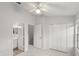 Bright bedroom with a ceiling fan, closet, and ensuite bathroom at 8615 Hunters Key Cir, Tampa, FL 33647