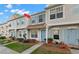 Charming townhome featuring light blue shutters, a light blue door, and a well-manicured lawn at 8615 Hunters Key Cir, Tampa, FL 33647